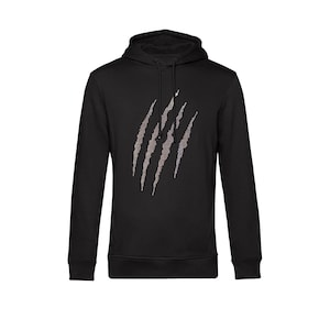 Può includere: Felpa con cappuccio nera con un design a graffio. I graffi sono costituiti da piccoli punti di colore chiaro. La felpa ha un cappuccio con coulisse e una tasca a marsupio. Un capo casual e confortevole.