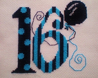May include: Cross-stitch design of the number 16 with blue and black yarn. The number 6 is striped and the number 1 has blue polka dots. A black balloon with a white star is attached to the number 6 with a blue string.