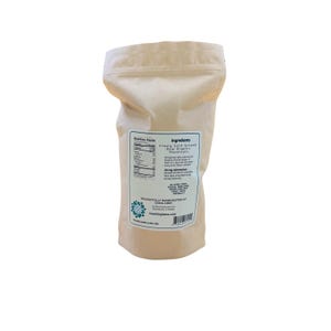 May include: A light tan, stand-up pouch containing finely cold-ground raw organic hazelnuts. The front label displays nutrition facts, ingredients, allergy information, and the text: Delightfully handcrafted at Lesna Corp, Northbrook, IL.