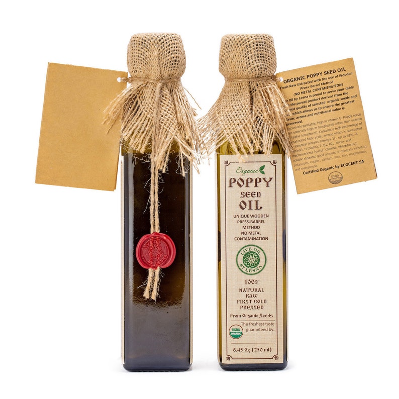 May include: Two glass bottles of organic poppy seed oil, each with a brown burlap lid and a red wax seal. The bottles are labeled with the words "Organic Poppy Seed Oil" and "Live Oil by Less". The bottles are 8.45 oz (250 ml).