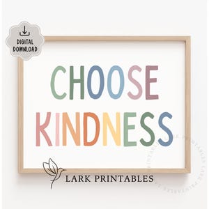 May include: A printable wall art print with the text "Choose Kindness" in a rainbow of colors. The text is in a playful, hand-drawn font. The print is framed in a light wood frame.