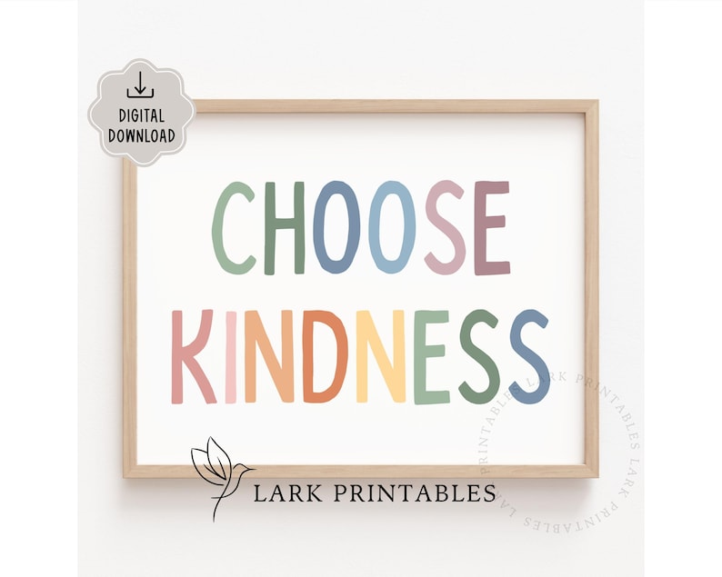 May include: A printable wall art print with the text "Choose Kindness" in a rainbow of colors. The text is in a playful, hand-drawn font. The print is framed in a light wood frame.