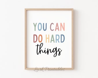 May include: A framed print with the text "You can do hard things" in a rainbow of colors. The text is in a playful font and is centered on the white background.