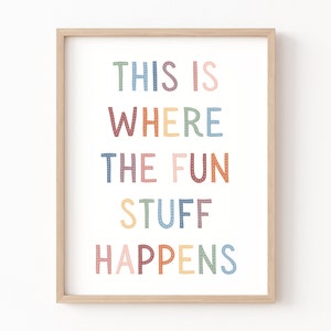 May include: A framed print with the text "This is where the fun stuff happens" in colorful, dotted letters.