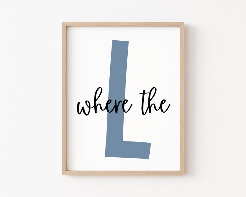 May include: A framed print with a light blue letter L and the text "where the" in black cursive font.