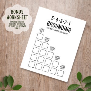 May include: A black and white printable worksheet titled "5-4-3-2-1 Grounding" with a pyramid-shaped grid of boxes. The text "Take a deep breath and identify..." is below the title. The worksheet is designed to help people ground themselves by identifying things they can see, touch, hear, smell, and taste.