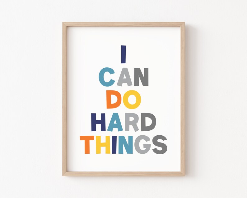 May include: A framed print with the text "I CAN DO HARD THINGS" in a colorful stacked design. The letters are in shades of blue, orange, yellow, and gray.
