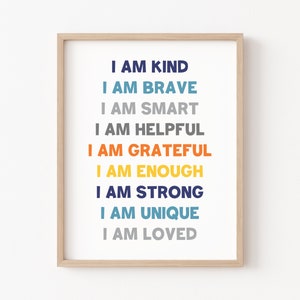 May include: A framed print with the text "I am kind, I am brave, I am smart, I am helpful, I am grateful, I am enough, I am strong, I am unique, I am loved." The text is in different colors, including blue, orange, yellow, and gray.