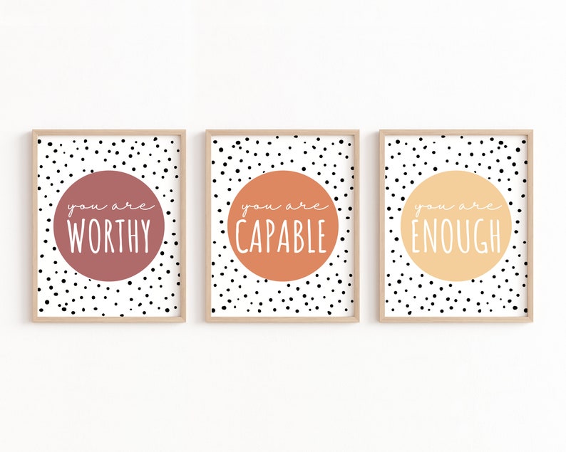 May include: Three framed prints with black polka dots on a white background. Each print features a large circle with a different color and the text "you are" followed by a word: "worthy", "capable", and "enough".