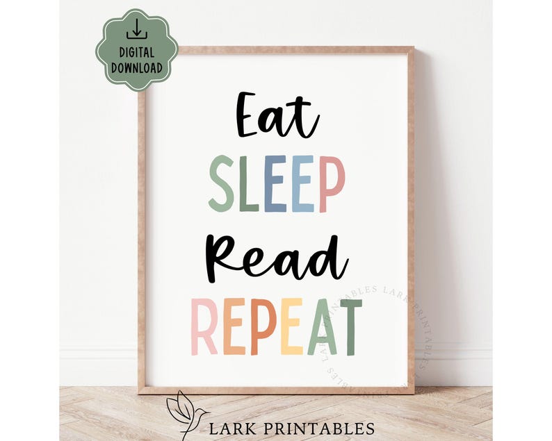 May include: A framed print with the words "Eat SLEEP Read REPEAT" in black, green, pink, blue, orange, and yellow. The print has a light brown frame and a digital download icon in the upper left corner.