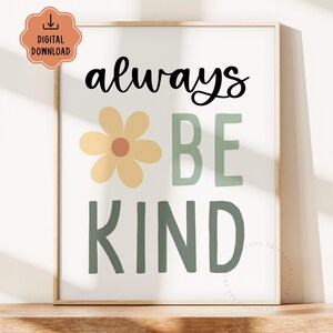 May include: A framed print with the words "always BE KIND" in black and green, with a yellow flower graphic. The print is a digital download, indicated by a peach-colored icon in the upper left corner. The artwork is displayed on a wooden surface.