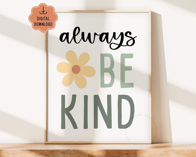 May include: A framed print with the words "always BE KIND" in black and green, with a yellow flower graphic. The print is a digital download, indicated by a peach-colored icon in the upper left corner. The artwork is displayed on a wooden surface.