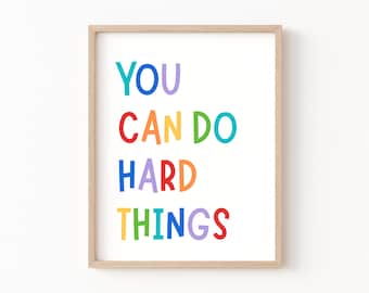 May include: A framed print with the text "YOU CAN DO HARD THINGS" in a rainbow of colors. The letters are stylized and playful.