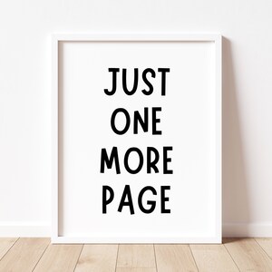 May include: White framed print with black text that reads "JUST ONE MORE PAGE".