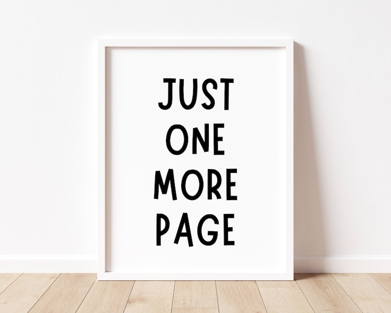 May include: White framed print with black text that reads "JUST ONE MORE PAGE".
