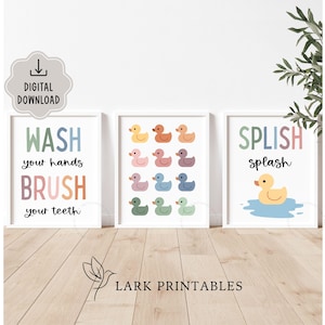 May include: Three framed prints with white borders. One print reads "WASH your hands BRUSH your teeth" in colorful text. Another features colorful duck illustrations. The third says "SPLISH splash" with a duck in water. "DIGITAL DOWNLOAD" is in the top left.