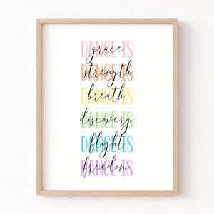 May include: A framed print with the text "Dance is grace, Dance is strength, Dance is breath, Dance is discovery, Dance is flight, Dance is freedom" in a rainbow of colors.