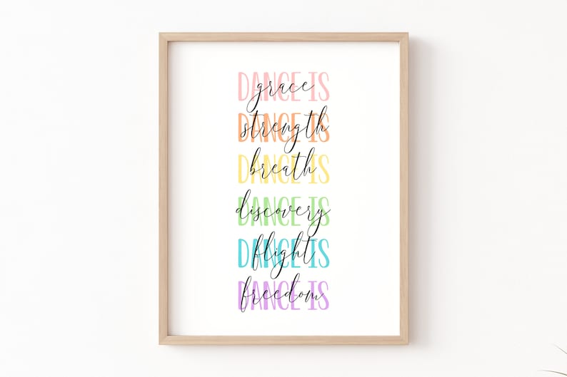 May include: A framed print with the text "Dance is grace, Dance is strength, Dance is breath, Dance is discovery, Dance is flight, Dance is freedom" in a rainbow of colors.