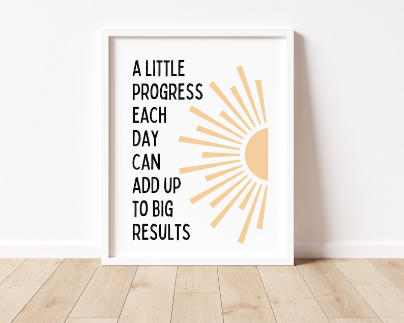 May include: A motivational quote, "A little progress each day can add up to big results", is displayed in black text on a white background. A stylized sun with orange rays is on the right side of the quote.