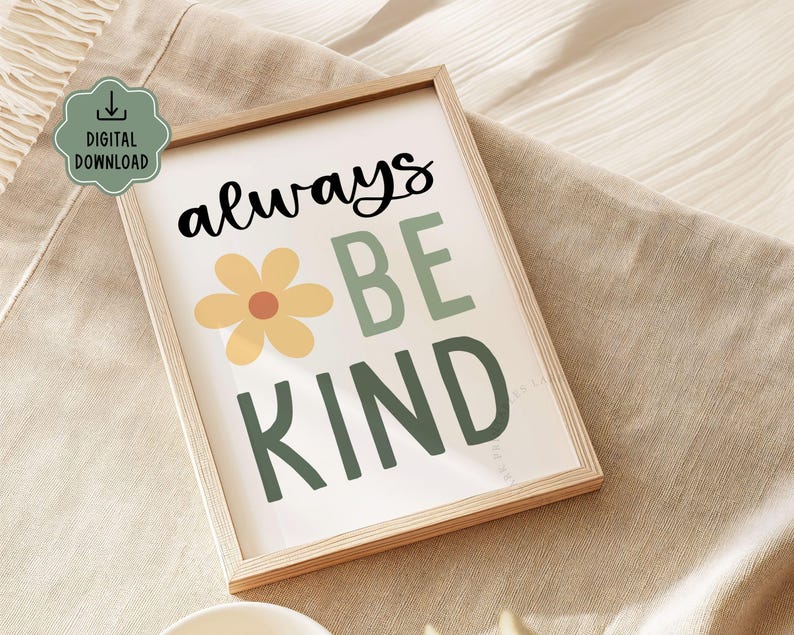 May include: A framed print with the words "always BE KIND" in black and green lettering, with a yellow flower graphic. The print is in a light wood frame and has a "DIGITAL DOWNLOAD" icon in the upper left corner.