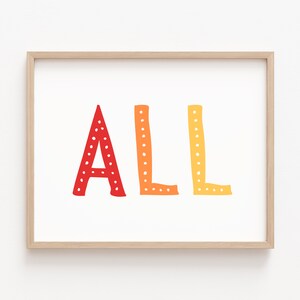 May include: A framed print with the word "ALL" in large, colorful letters. The letters are red, orange, and yellow, with a dotted pattern. The frame is a light wood color, and the background is white.