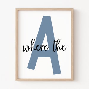 May include: A framed print featuring a large blue letter A and the text "where the" in black script.