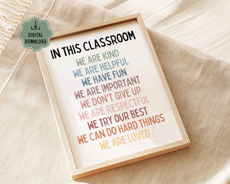 May include: A framed classroom poster with the text "In this classroom we are kind, we are helpful, we have fun, we are important, we don't give up, we are respectful, we try our best, we can do hard things, we are loved". The text is in a rainbow of colors.