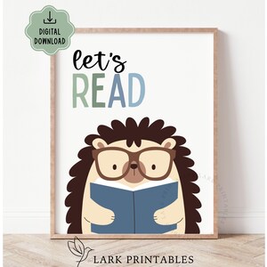 May include: A framed print featuring a cartoon hedgehog wearing glasses and reading a blue book. The words "let's READ" are displayed above the hedgehog in green and blue lettering. The print is a digital download.