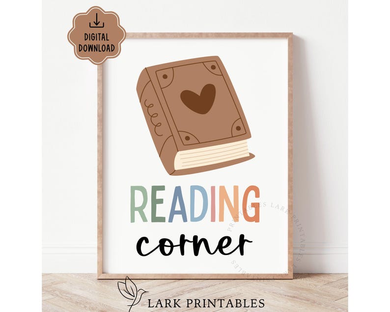 May include: A framed print with a brown book illustration and the words "READING corner" in colorful text. The book has a heart on the cover. A digital download icon is in the upper left corner.