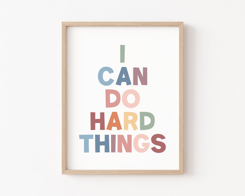 May include: A framed print with the text "I CAN DO HARD THINGS" in a rainbow of colors. The text is in a bold, sans-serif font.