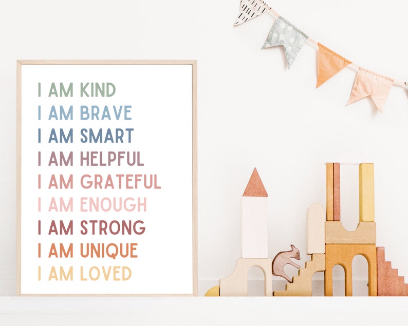 May include: A framed print with a white background and a colorful text overlay. The text reads "I am kind, I am brave, I am smart, I am helpful, I am grateful, I am enough, I am strong, I am unique, I am loved".