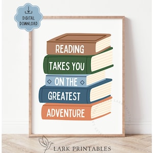 May include: A framed print featuring a stack of illustrated books in brown, green, blue, and orange. The books display the words "READING TAKES YOU ON THE GREATEST ADVENTURE" in white. A digital download icon is in the upper left corner.