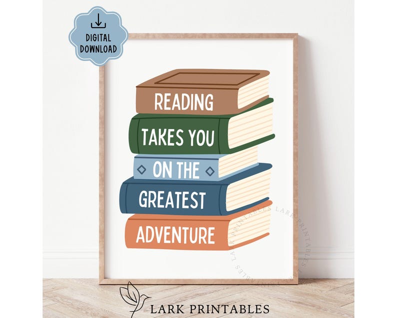 May include: A framed print featuring a stack of illustrated books in brown, green, blue, and orange. The books display the words "READING TAKES YOU ON THE GREATEST ADVENTURE" in white. A digital download icon is in the upper left corner.