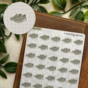 May include: A sticker sheet featuring multiple small, sage green running shoe illustrations arranged in a grid pattern. Each individual sticker depicts a pair of athletic trainers with a simple outline, light green accents, and a white sole.