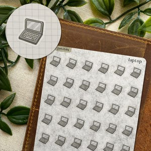 May include: Laptop stickers in a repeating pattern on a light grey background. The stickers are grey and white, with a laptop design. The word "laptop" is printed on the sticker sheet. A round sticker with a laptop design is also present.