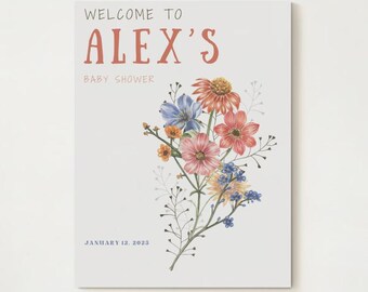 May include: A white card with the text "Welcome to Alex's Baby Shower" in black and red text. The card is decorated with a watercolour illustration of a bouquet of flowers in shades of pink, blue, orange, and yellow.