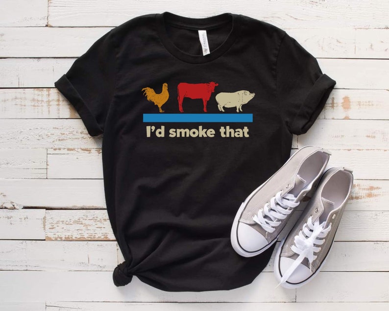 May include: Black t-shirt with a graphic of a chicken, cow, and pig with the text "I'd smoke that".