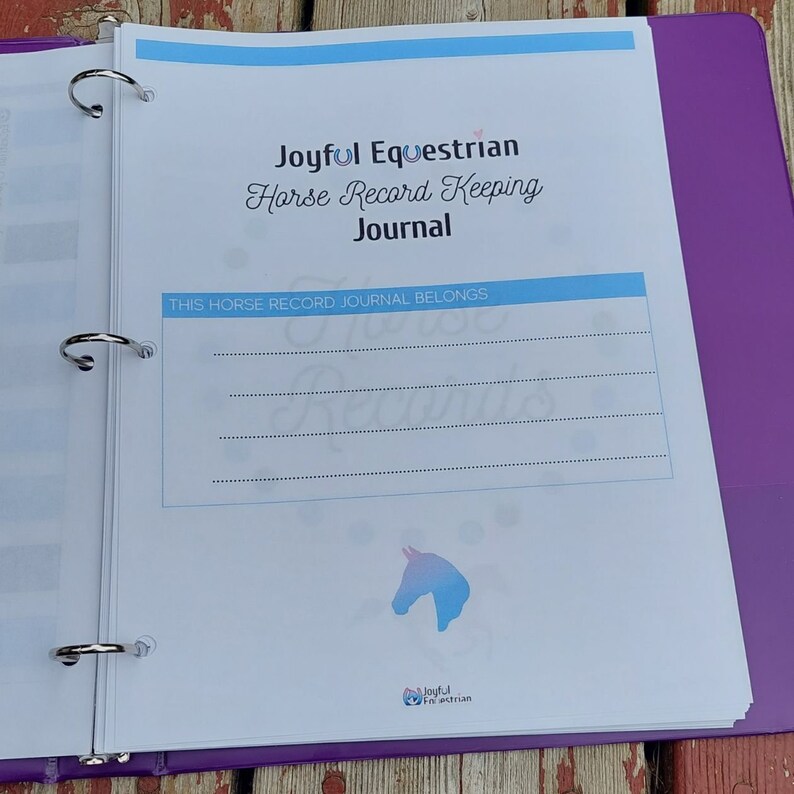 May include: A blue and white binder with the text "Joyful Equestrian Horse Record Keeping Journal" on the front. The text "This Horse Record Journal Belongs To" is printed below the title. A blue and white horse head silhouette is printed on the front cover.