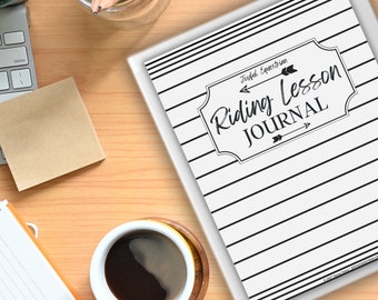 May include: A black and white striped journal with the text "Joyful Equestrian Riding Lesson Journal" in a black frame with arrows pointing to the left and right.