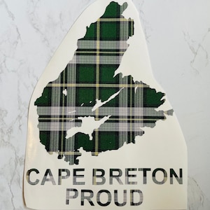 Peut inclure: Un autocollant blanc représentant le contour de l'île du Cap-Breton, rempli d'un motif écossais vert, noir et jaune. Les mots "CAPE BRETON PROUD" sont imprimés en gras, en noir, en dessous.