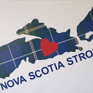 May include: A blue and green tartan outline of Nova Scotia with a red heart in the centre. The text "NOVA SCOTIA STRONG" is written below the outline.