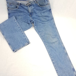 May include: A pair of light blue denim jeans with a straight leg fit.