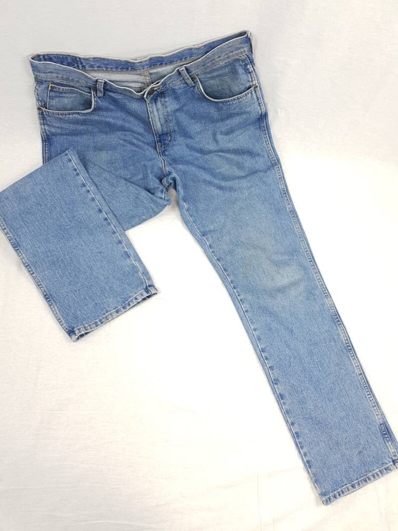 May include: A pair of light blue denim jeans with a straight leg fit.