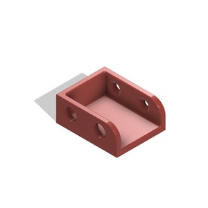 May include: A red plastic bracket with four holes. The bracket has a rectangular shape with a curved edge on one side.