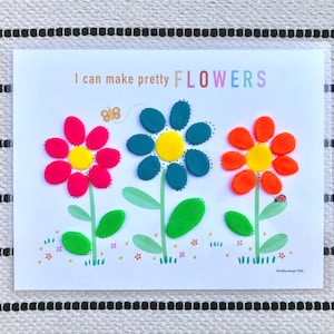 May include: A printable activity sheet with the text "I can make pretty FLOWERS" and an illustration of three flowers made from playdough. The flowers are red, blue, and orange with yellow centers. The flowers have green stems and leaves.