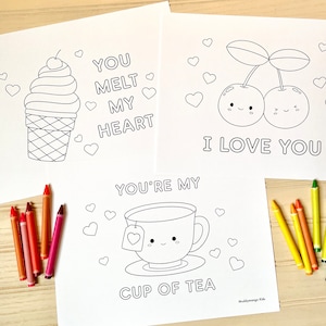 May include: Three printable coloring pages with cute illustrations and Valentine's Day themed messages. The first page features an ice cream cone with the text "You melt my heart". The second page features two cherries with the text "I love you". The third page features a teacup with the text "You're my cup of tea".