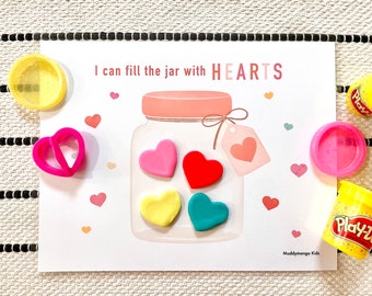 May include: A printable activity card with a jar and the text "I can fill the jar with HEARTS". The jar has four hearts inside, one red, one pink, one yellow, and one blue. There are also Play-Doh containers and a heart-shaped cookie cutter.