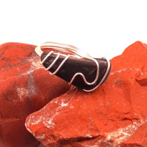 Smooth black Hill Country stone with funky wire setting, Rock ring