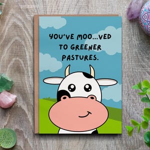 Biglietto di auguri per la nuova casa - Traslocare verso pascoli più verdi, divertente biglietto con gioco di parole. Biglietto di auguri con mucca e paesaggio rurale.