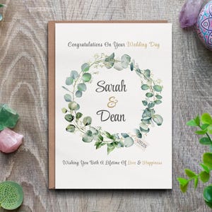 Cartão de casamento personalizado - Design de guirlanda floral com nome do casal e ano do casamento.